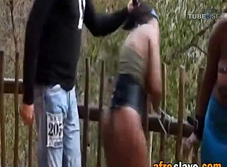 Full-bosomed African slaves getting tortured outdoors